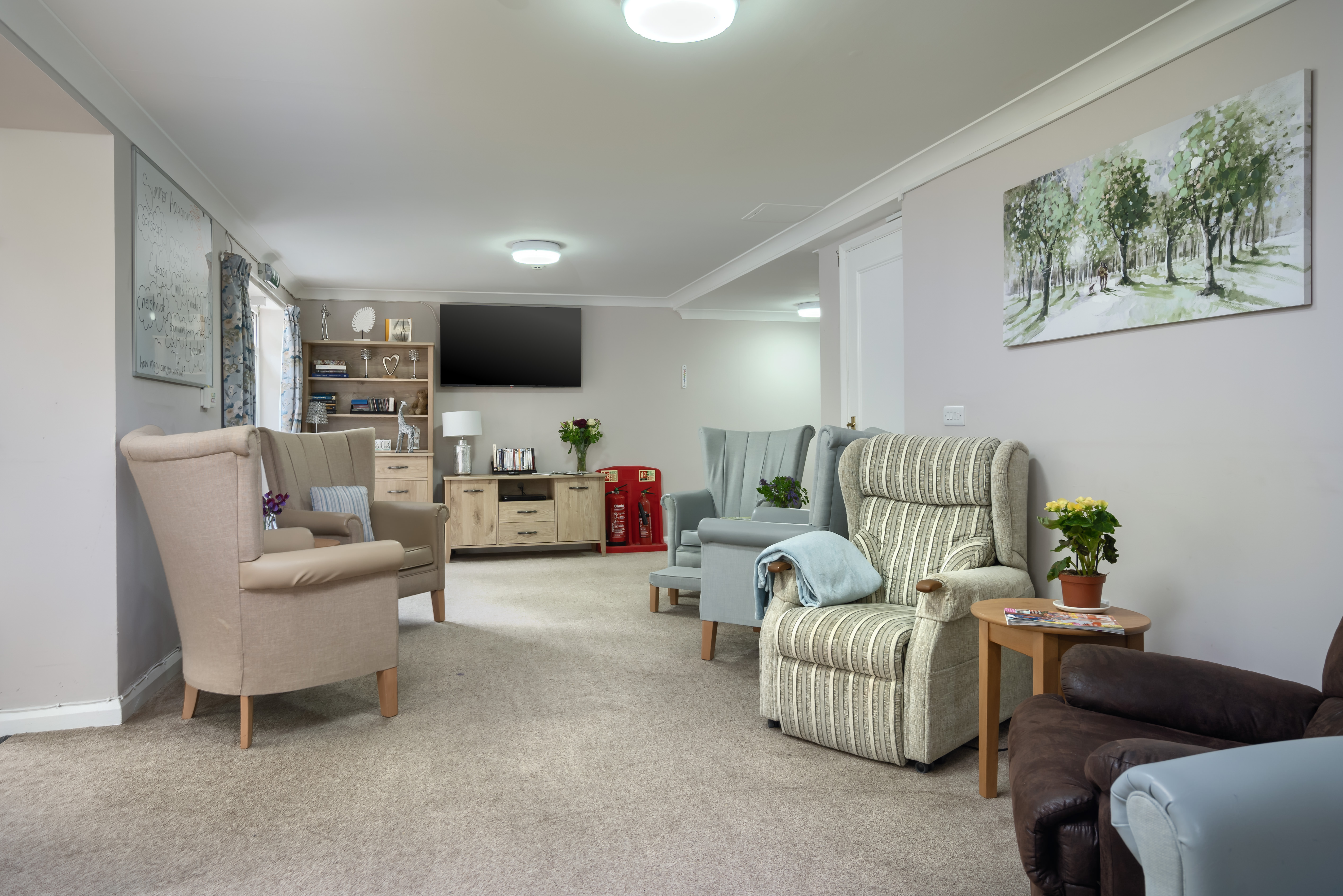 Pratt House lounge in brightly lit room with seating and TV