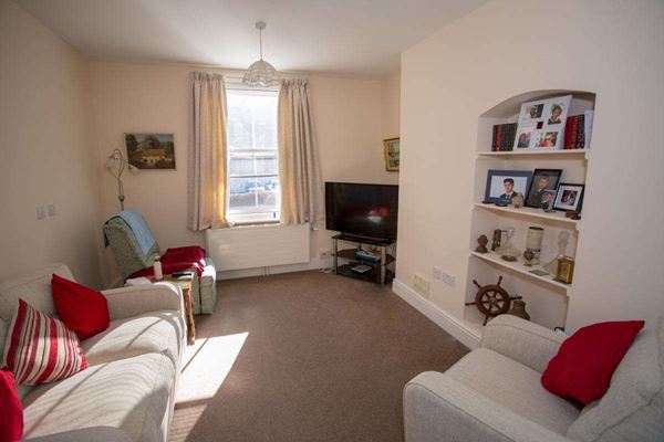 Bright communal lounge where residents can enjoy watching the TV, relaxing or socialising at Abbeyfield House,