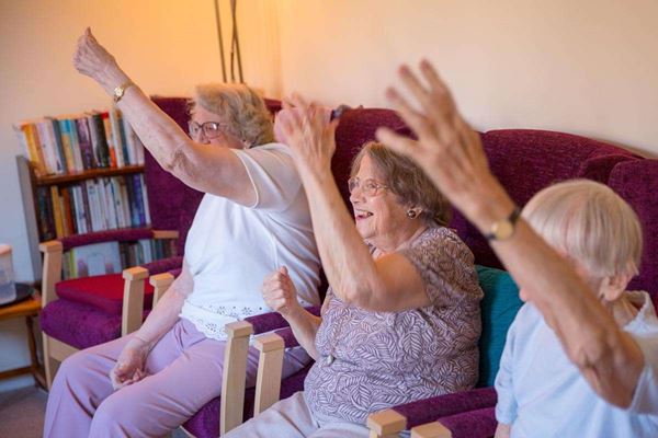 Residents enjoying some chair based exercises at Abbeyfield House