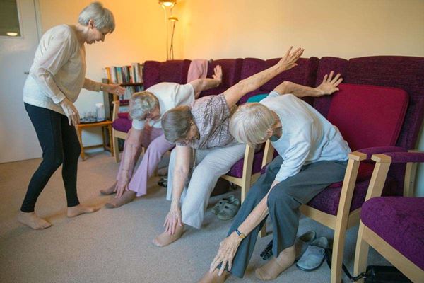 Residents taking part in armchair based exercises at Abbeyfield House